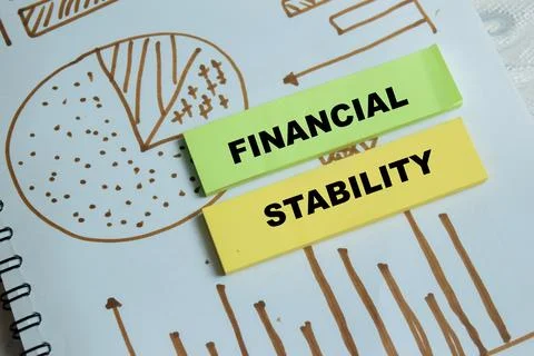 Concept of financial stability write on sticky notes isolated on Wooden Table Stock Photos