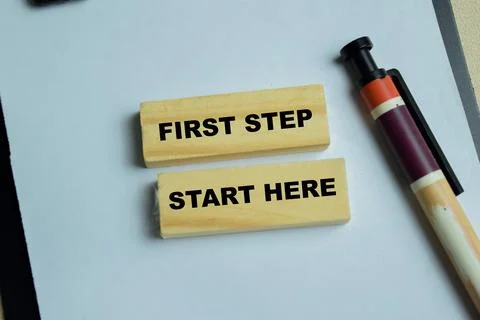 Concept of first step start here text on wooden blocks Stock Photos