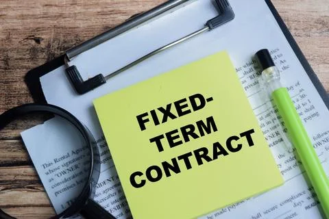 Concept of fixed term contract write on sticky notes isolated on Wooden Table Stock Photos