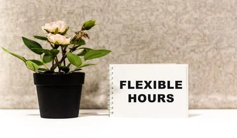 The concept of flexible work policy. The text on the notepad Stock Photos