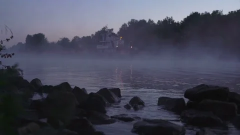 Concept of flying Dutchman. Barge with garbage appears and disappears from fog Stock Footage 77922486