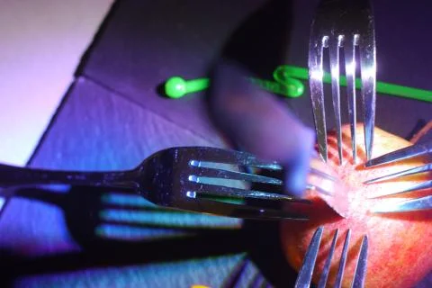 Concept of forks puncturing an apple Stock Photos