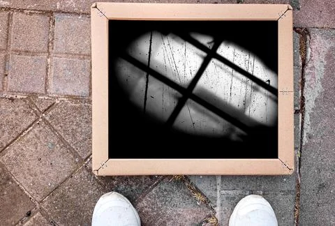 Concept of freedom. Shadow of bars framed on the pavement. Stock Photos