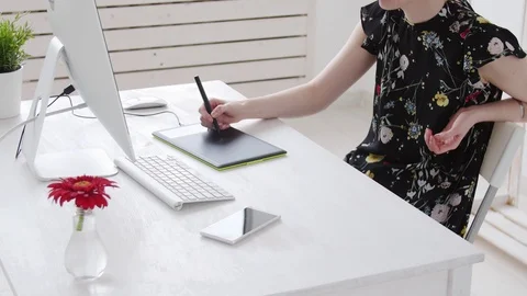 Concept of freelancing or office work. Young female photographer, retoucher or Stock Footage 106758800