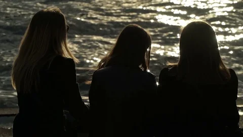 Concept of friendship teenagers. Group of three girls watching sunset on the Video stock 78340053