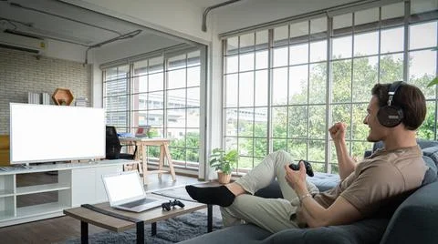 Concept, game or e-sport. Young Caucasian man, white, holding, joystick, game Stock Photos