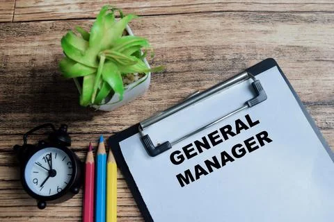 Concept of general manager write on clipboard isolated on Wooden Table. Stock Photos
