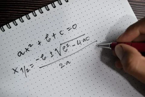 Concept of general quadratic equation write on book isolated on Wooden Table. Stock Photos