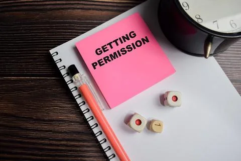 Concept of Getting permission write on sticky notes isolated on Wooden Table. Stock Photos