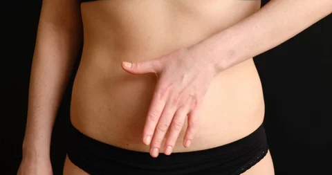 The concept of getting rid of excess weight. Girl cuts off fat deposits with Stock Footage 126364191