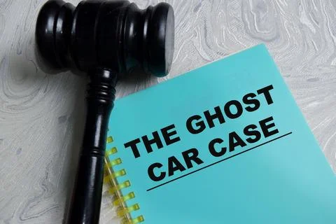 Concept of the ghost car case write on book isolated on Wooden Table. Stock Photos