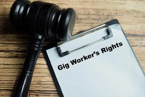 Concept of gig worker's rights write on clipboard isolated on Wooden Table. Stock Photos