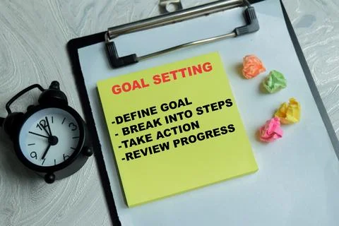 Concept of goal setting write on sticky notes isolated on Wooden Table. Stock Photos