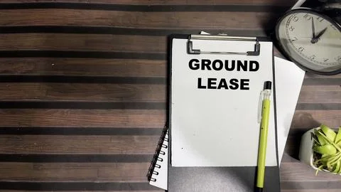 Concept of Ground Lease write on paperwork isolated on Wooden Table. Fotos de archivo