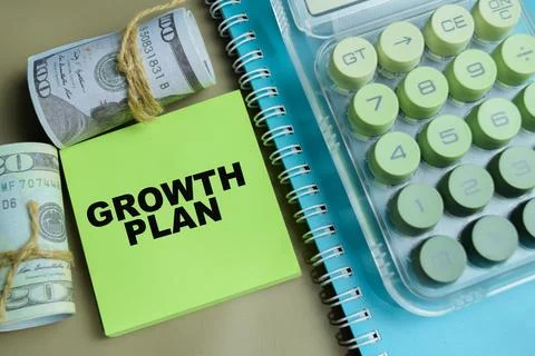 Concept of growth plan write on sticky notes isolated on Wooden Table. Stock Photos