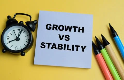 Concept of growth vs stability write on sticky notes isolated on table. Stock Photos