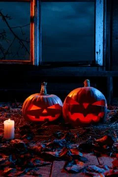 The concept of Halloween. Two luminous evil scary pumpkins, jack-lantern, wit Stock Photos