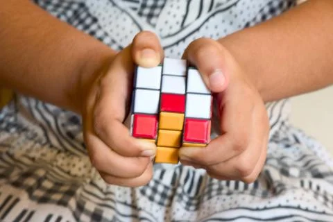 Concept ; hand playing with Rubik puzzle cube game MR 201 Copyright: xVxMi... Stock Photos