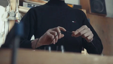 The concept of handmade crafting style. Close-up of wire in male hands Stock-Footage 73012635