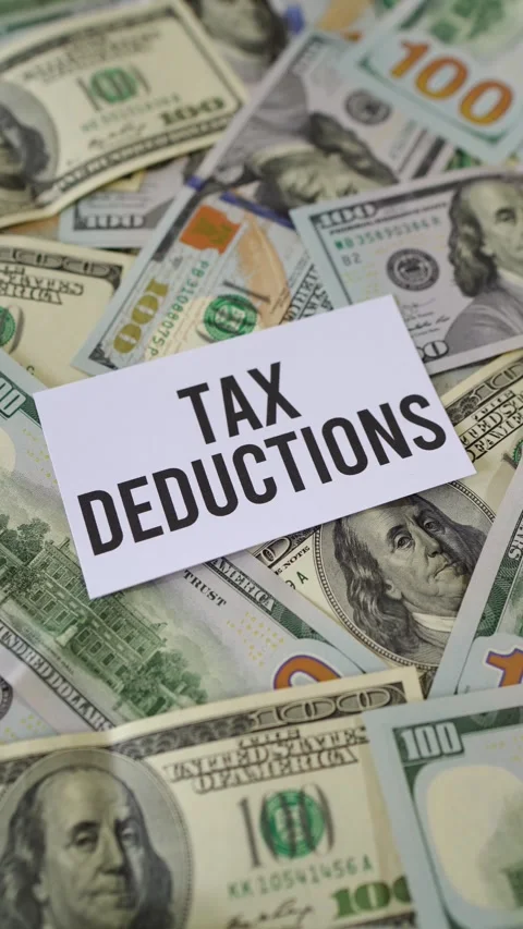 Concept of having tax deductions and saving money on taxes. Vertical shot. Stock Footage 302924334