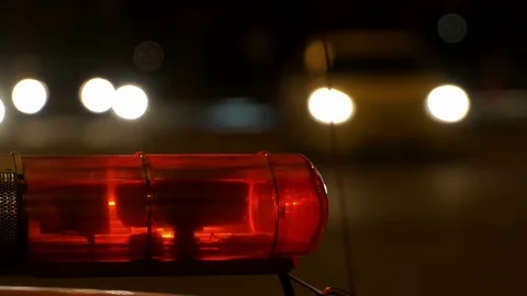 Concept help and rescue. Nihgt city road and flashing lights on top police Stock Footage 76049601