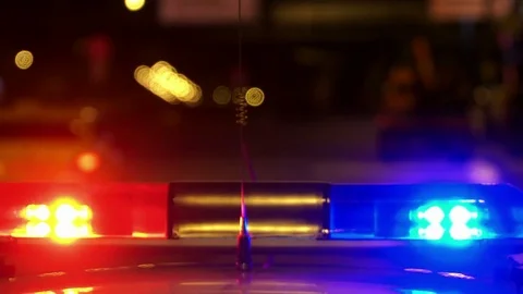 Concept help and rescue. Nihgt city road and flashing lights on top police Stock Footage 76751377