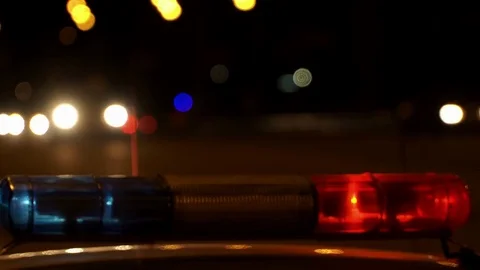 Concept help and rescue. Nihgt city road and flashing lights on top police Stock Footage 76811737