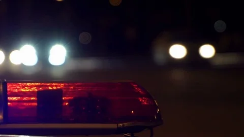 Concept help and rescue. Nihgt city road and flashing lights on top police Stock Footage 77266487