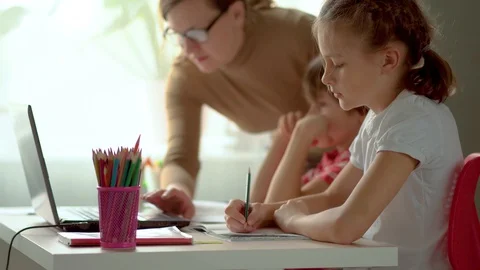 Concept home studying. Boy and girl use laptop for education. Children have Stock Footage 129575268