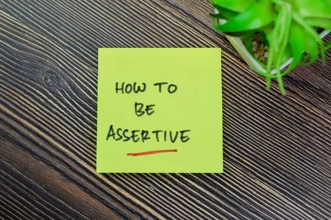 Concept of How to Be Assertive write on sticky notes isolated on Wooden Table Stock Photos