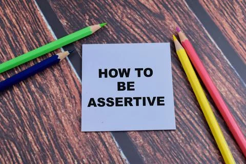 Concept of How to be Assertive write on sticky notes isolated on Wooden Table Stock Photos