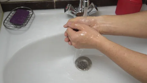 The concept of hygiene, soaping hands and washing them in the bathroom. Stock Footage 127707158