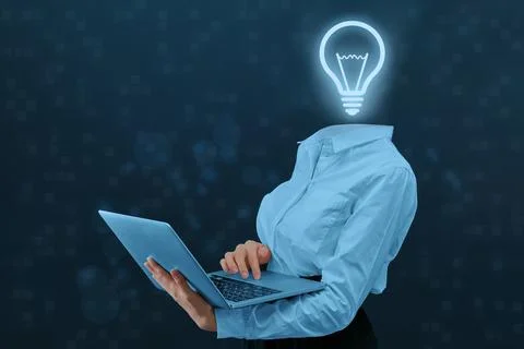 Concept idea and its development. Person with a laptop and a light bulb inste 스톡 사진