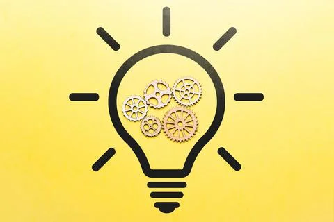Concept idea and its development. Icon of a light bulb and working gears. 스톡 사진