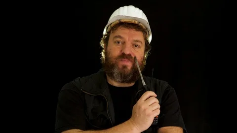 Concept idea: Bearded construction worker is slowly becoming very tired and y 库存影片 121601705