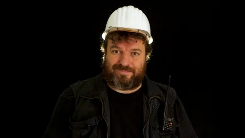 Concept idea: Bearded man wearing hardhat takes measure from screen with tape Stock Footage 121600356