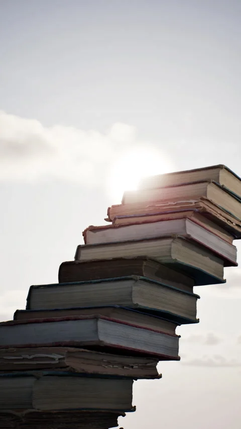 Concept idea stack of books on sky sun Rise beautiful background. Stock Footage 336718113