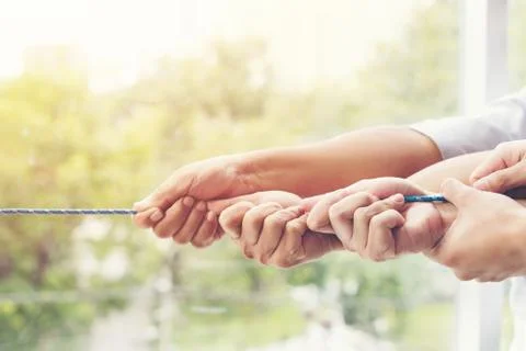Concept image of business team using a rope as an element of the teamwork Stock-Fotos