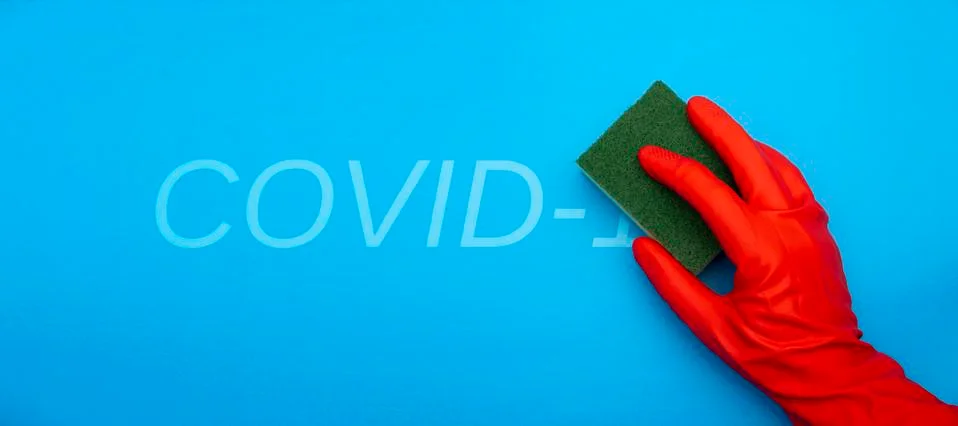 Concept image of hand in red rubber protecting glove holding sponge with gree Stock Photos