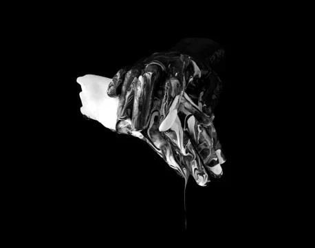 Concept image of two hands covered in black and white paint touching Stock Photos