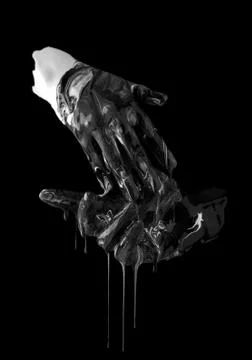 Concept image of two hands covered in black and white paint touching Stock Photos