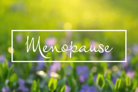 Concept of impending menopause. Blurred view of beautiful periwinkle flowers  Stock Photos