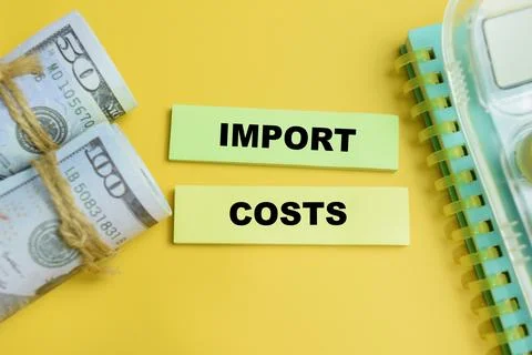 Concept of import costs write on sticky notes isolated on table. Stock Photos