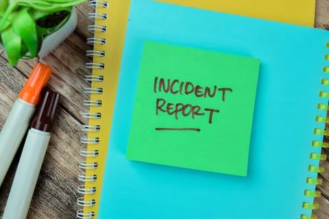 Concept of Incident Report write on sticky notes isolated on Wooden Table. Stock Photos