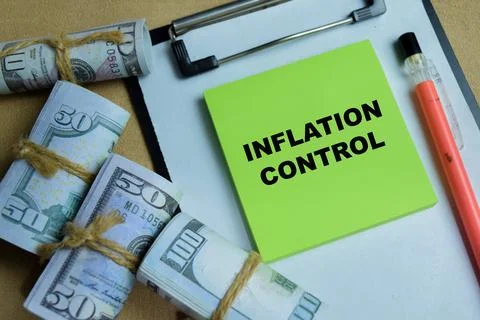 Concept of inflation control write on sticky notes isolated on Wooden Table. Stock Photos