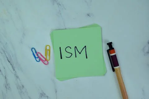 Concept of ISM write on sticky notes isolated on Wooden Table. Stock Photos