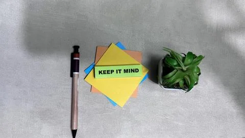 Concept of Keep it Mind write on sticky notes isolated on Wooden Table. Stock Photos