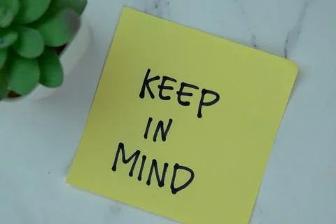 Concept of Keep in Mind write on sticky notes isolated on Wooden Table. Stock Photos