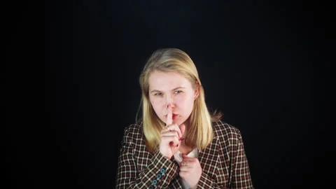Concept of keeping words secret, keeping a mystery by young blonde woman Stock Footage 309686486