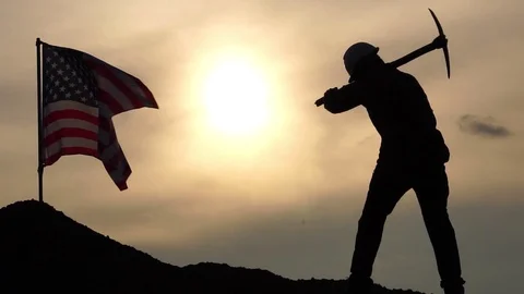 Concept Labor Day: Labor man standing holding a pickaxe with the United States Stock Footage 106455163